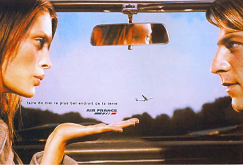 Flight ad of a woman and men sitting in a car and seeing a plane on the sky
