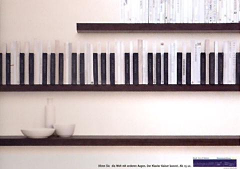 Ad for a piano shop showing the sky with a line of hanging socks in shape of piano keys in the forground