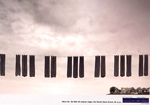 Ad for a piano shop showing the sky with a line of hanging socks in shape of piano keys in the foreground