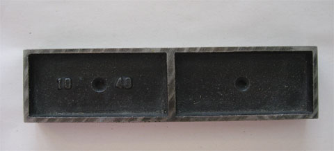Metal that helps to position the letter blocks on the press in the size 40 x 10 pica