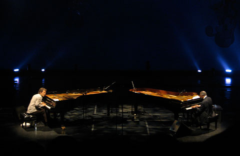 Brad Mehldau and Hank Jones on stage sitting on pianos