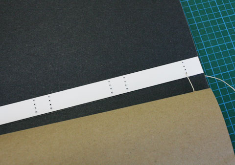 Visible thread on spine interior of book using European stitching binding