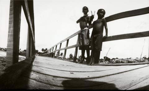 2 boys standing on bridge, from the pinhole photography project 'Favela - Ilha de Deus Pinhole'