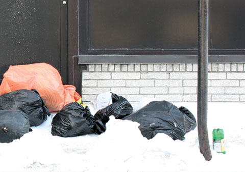 Orange and black Garbage Bags on Boulevard St Laurent, Corner Boulevard St-Joseph E on sidewalk