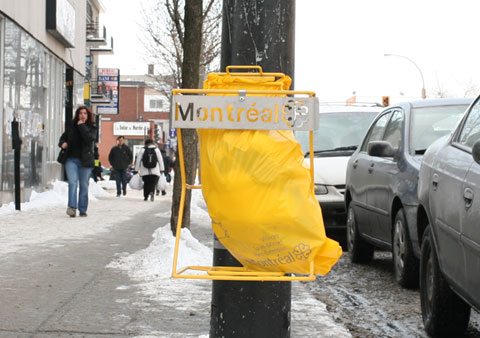 Garbage Can, which consists in a yellow plastic bag mounted on a street light, on Rue Jean-Talon E, Corner Avenue Henri-Julien