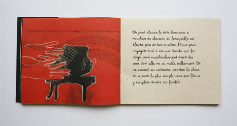 Book page with illustrated piano and text page