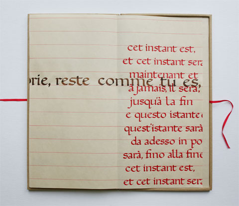 Open box with page containing mainly red calligraphic lines