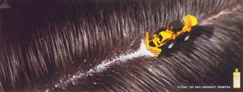 Ad for an anti-dandruff shampoo showing a miniature of a construction truck taking off the dandruffs