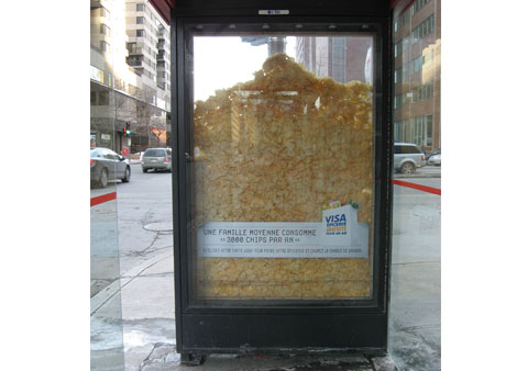 Ad showing a chips inside the window of a bus stop place