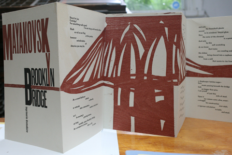 The book 'Brooklyn Bridge' standing on a surface which puts the accordion folding in evidence