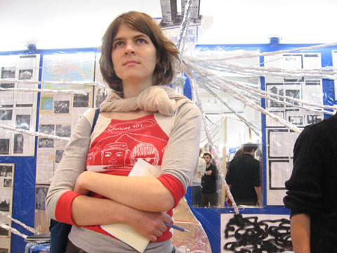 Individual standing in the installation space by Thomas Hirschhorn