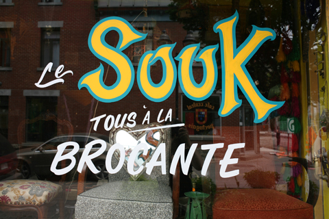 Detail of hand lettering of the word 'souk' on Montreal shop window