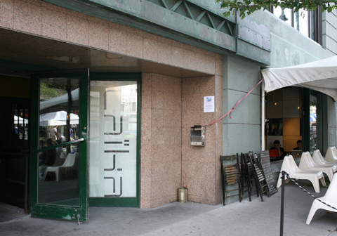 Logo of Cafe Laika and exterior view of cafe