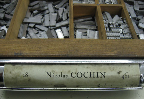 Part of letterpress case showimg the label with the name of the typeface which is Nicolas Cochin