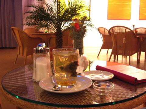 Table with tea glass next to other tables in the cultural centre Pasinger Fabrik