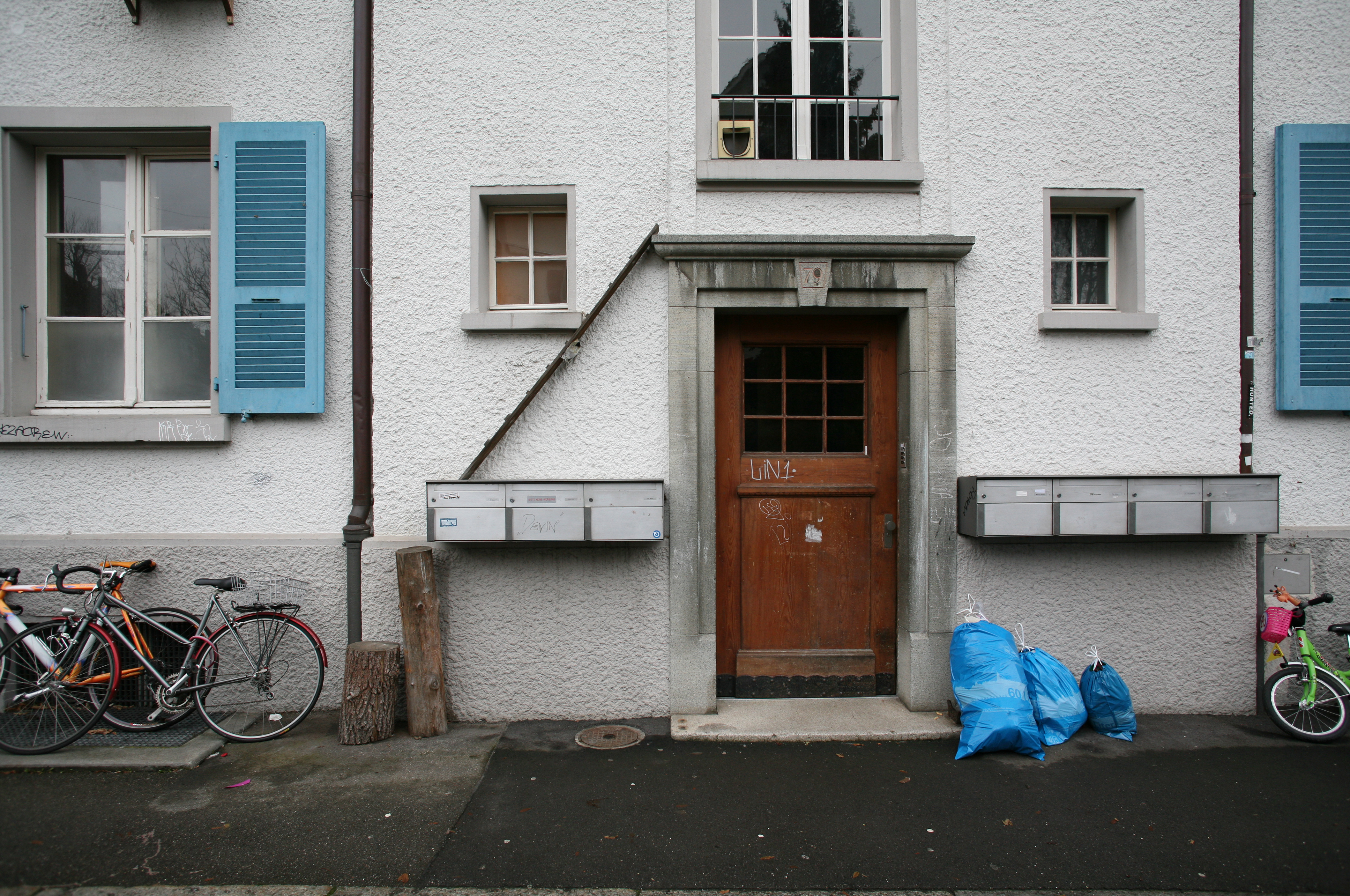 house entrance with mail boxes and a cat ladder