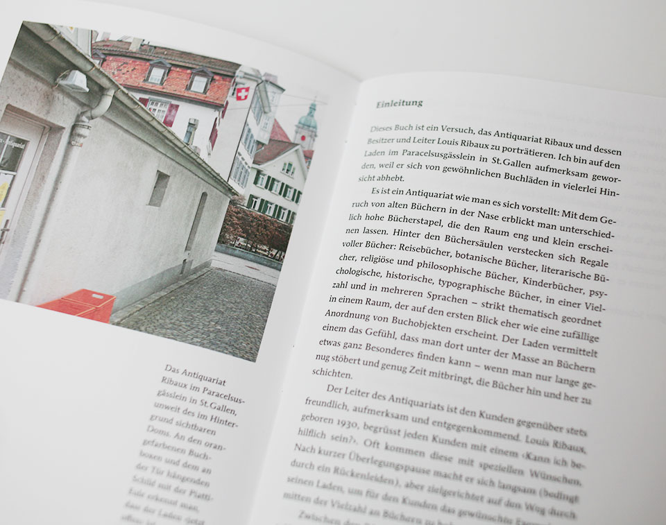 open spread of book containing text and an image with building