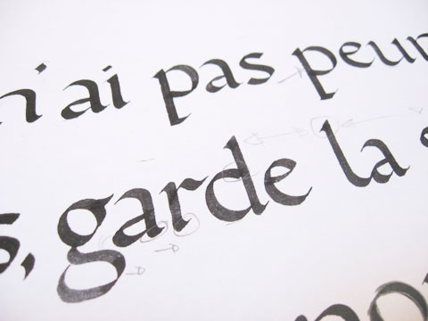 Foundational hand/roman minuscule letters with pencil corrections on paper